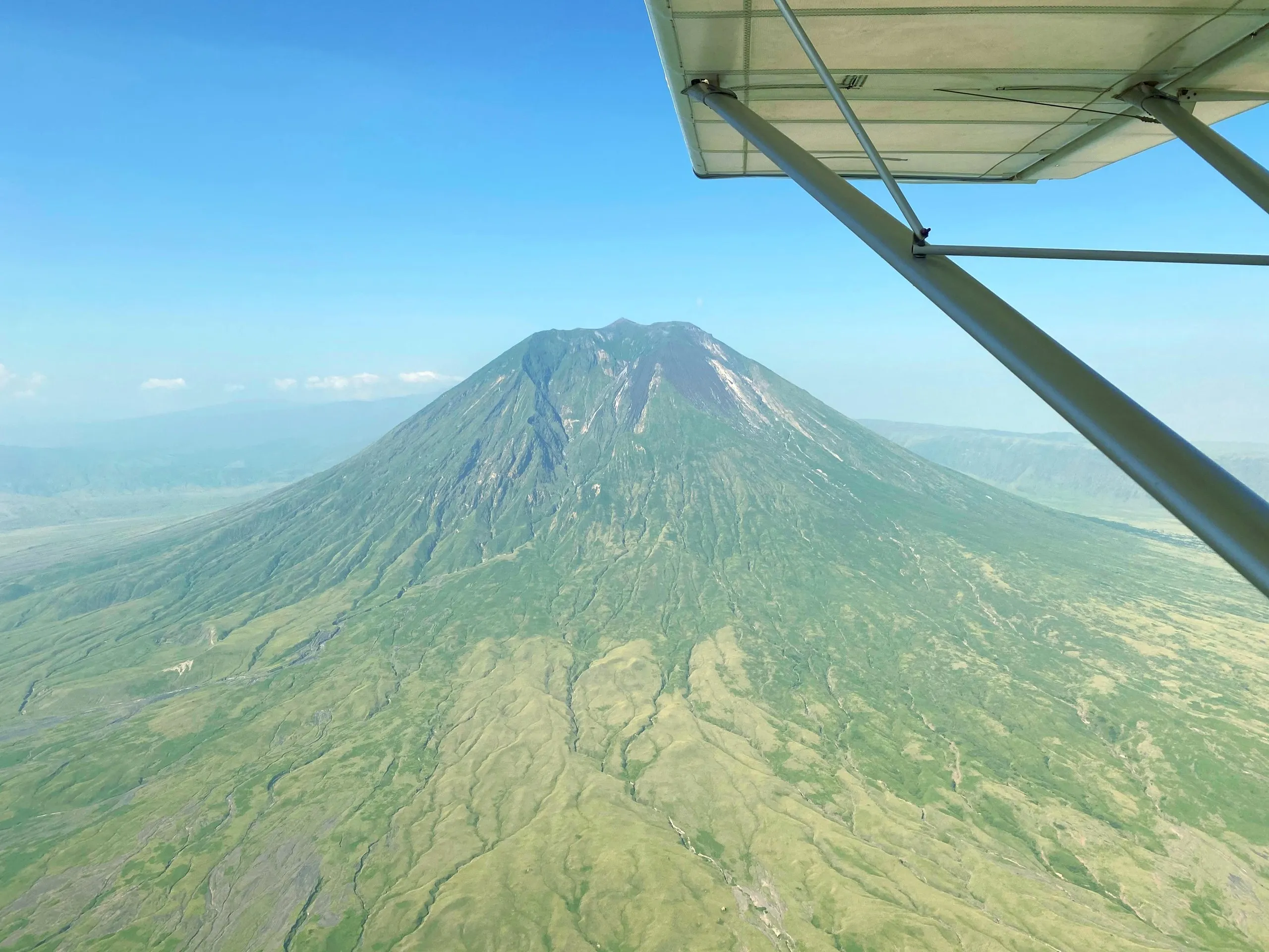 Ol Doinyo Lengai volcano in Tanzania seen from under the wing of a ZRP aircraft