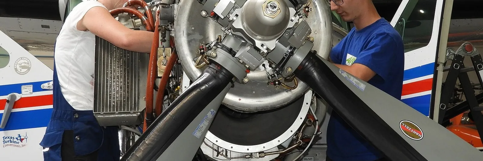 Mechanics servicing an aircraft engine