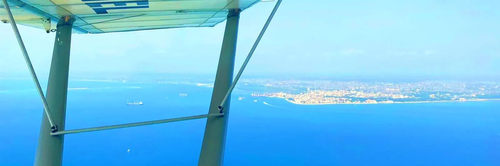 View over the Zanzibar coastline from under the wing of a light aircraft